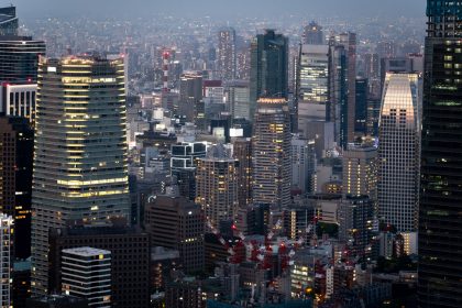 nighttime city buildings viewed from above, illustrating continuous systems and ongoing operational responsibility