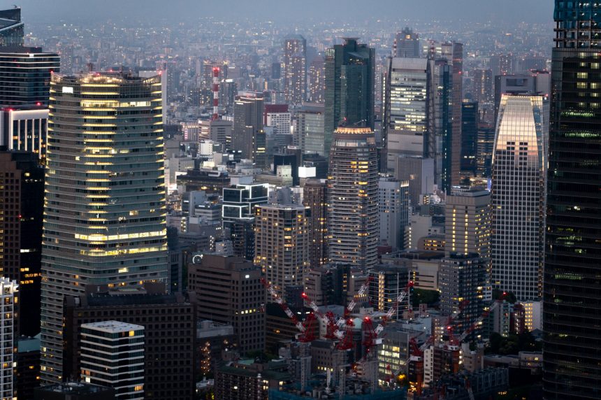 nighttime city buildings viewed from above, illustrating continuous systems and ongoing operational responsibility
