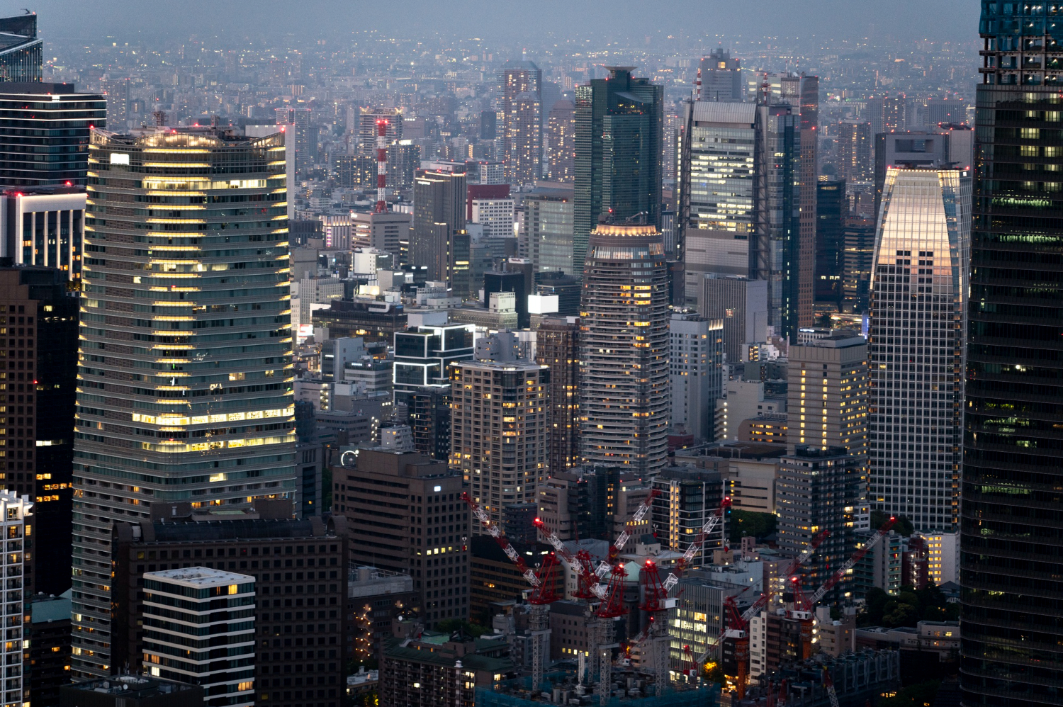 nighttime city buildings viewed from above, illustrating continuous systems and ongoing operational responsibility