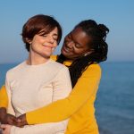 Couple standing together by the seaside symbolising mutual support, emotional balance, and healthy partnership.