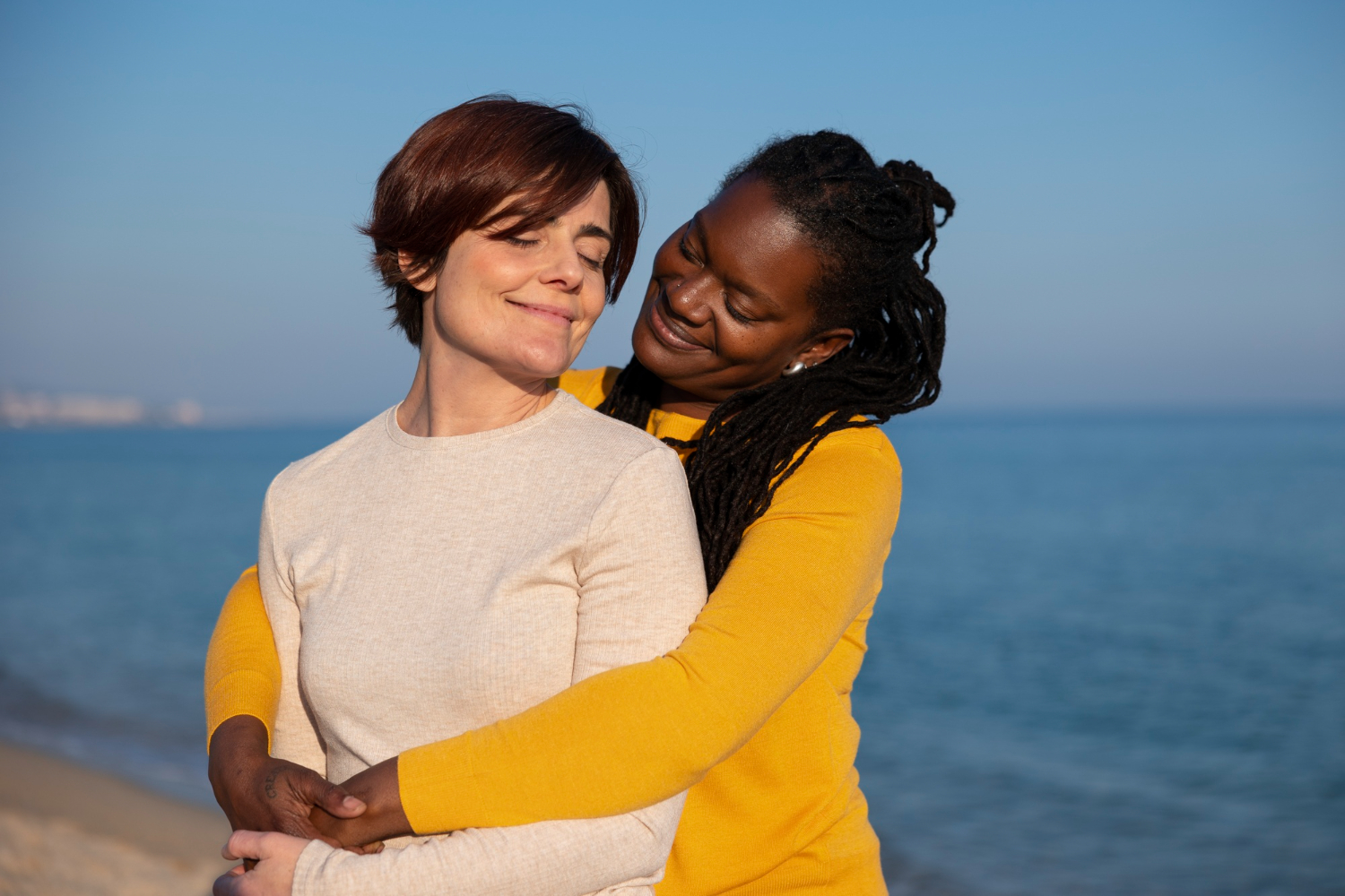 Couple standing together by the seaside symbolising mutual support, emotional balance, and healthy partnership.