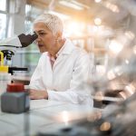 scientist examining chemical processes in a laboratory, representing experimental research behind modern scientific advances