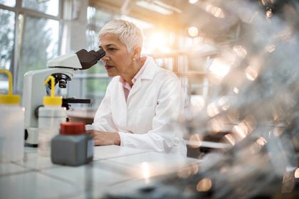 scientist examining chemical processes in a laboratory, representing experimental research behind modern scientific advances