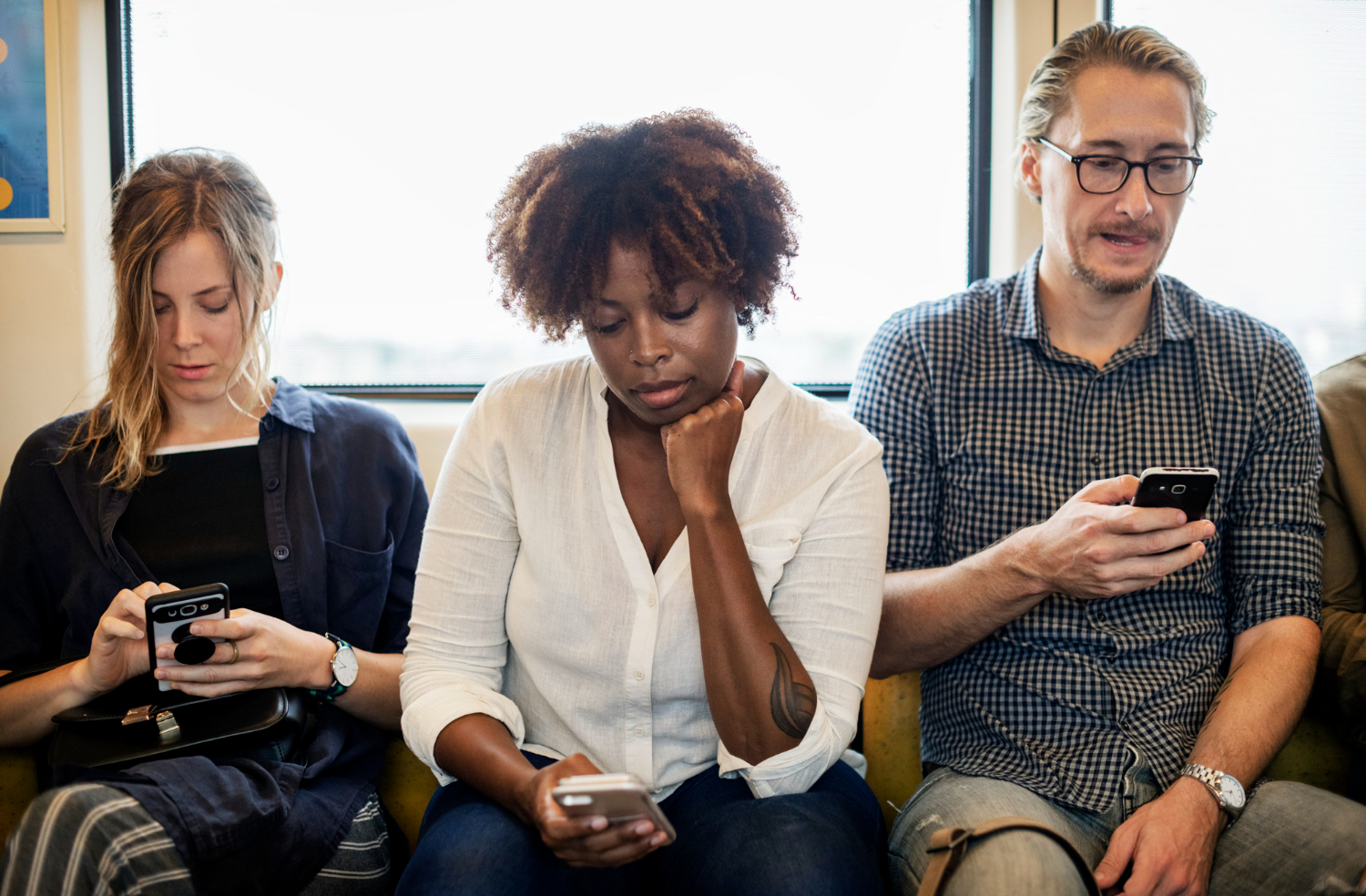 A diverse group of commuters on a train, each absorbed in their smartphones