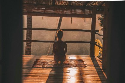 Woman meditating and practising breathing exercises to manage anxiety.