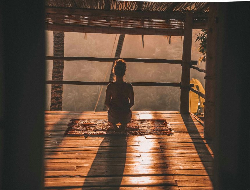Woman meditating and practising breathing exercises to manage anxiety.