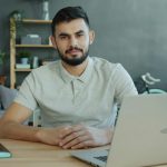 Small business owner reviewing marketing performance on laptop in a home office environment to guide data-driven growth decisions.