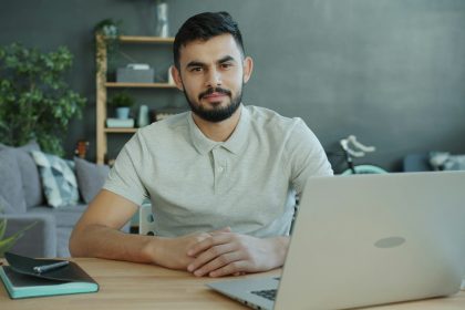 Small business owner reviewing marketing performance on laptop in a home office environment to guide data-driven growth decisions.