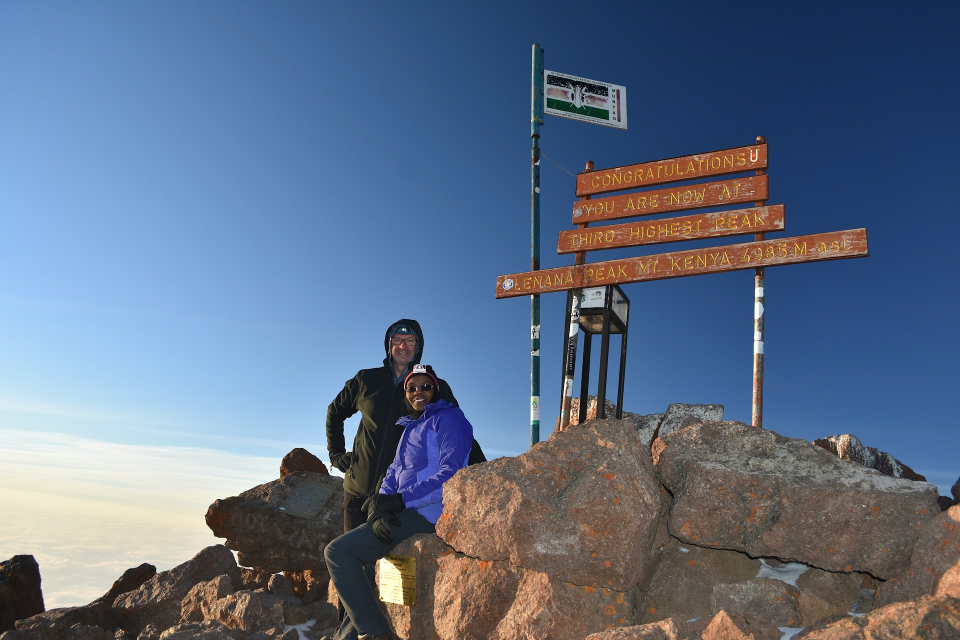 Hikers standing on a peak on Mount Kenya showing the experience of climbing and high-altitude landscape in Kenya